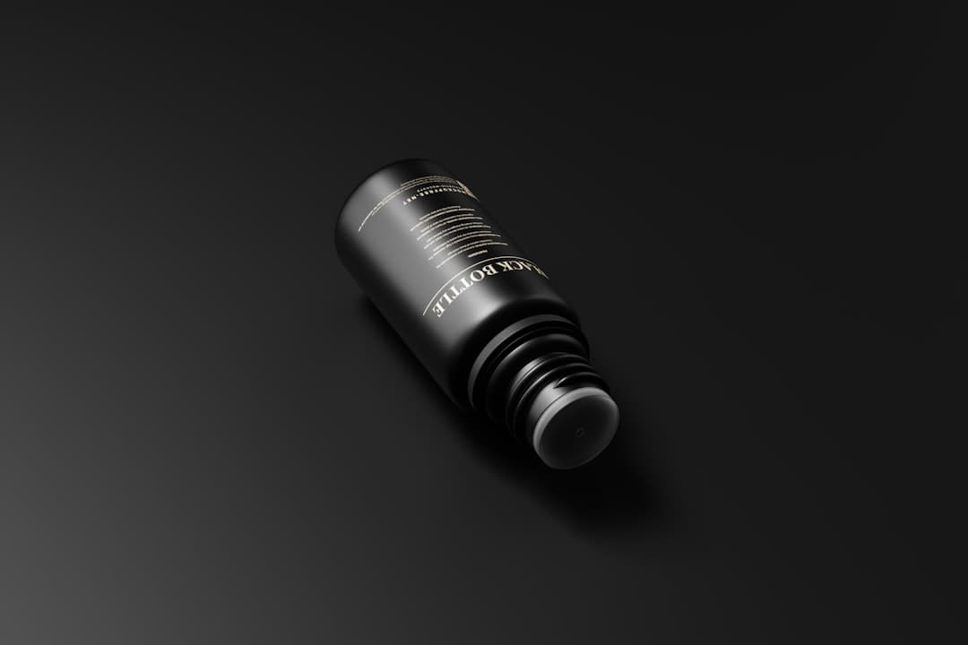 Close-up of a small medication vial on a dark surface