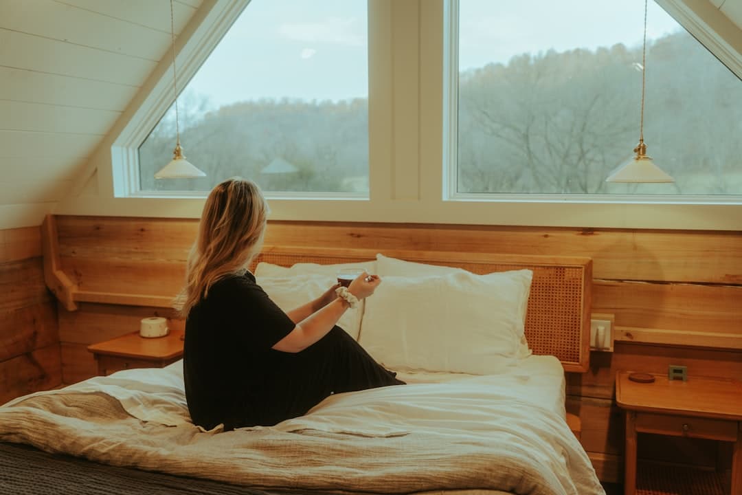 Person sitting in a sunlit room, contemplating their morning routine